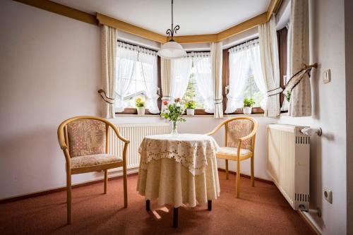 a dining room with a table and two chairs at Landhaus Weiß in Bad Reichenhall