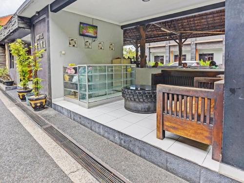 a restaurant with a bench on the side of a building at Hotel Diana 1 in Denpasar