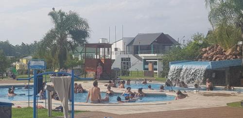 a group of people in a swimming pool with a waterfall at LAS MARIAS - CHAJARI in Chajarí