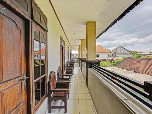 a row of chairs sitting on a balcony at Hotel Diana 1 in Denpasar