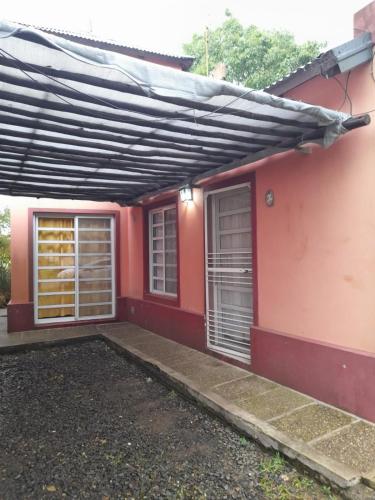 a red house with a black roof at LAS MARIAS - CHAJARI in Chajarí