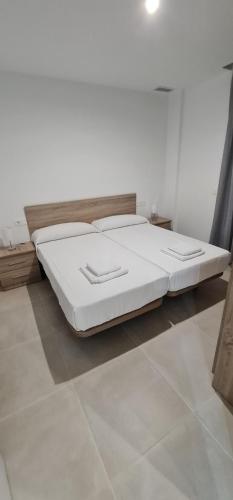 a large white bed in a room with at Apartamentos Tarifa Sun in Tarifa