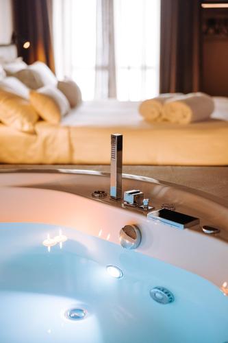 a bath tub in a room with a bed at Suite1212 - Bandiera in Monopoli
