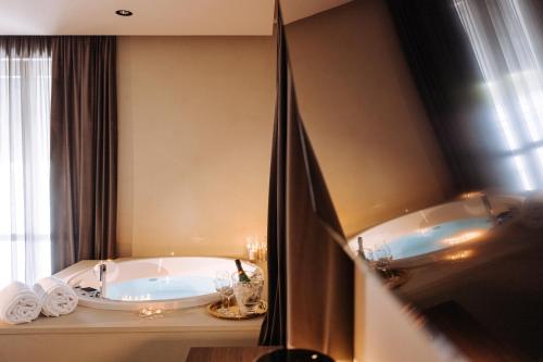 a bathroom with a tub and two sinks at Suite1212 - Bandiera in Monopoli