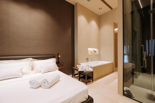 a hotel room with a bed and a bath tub at Suite1212 - Bandiera in Monopoli
