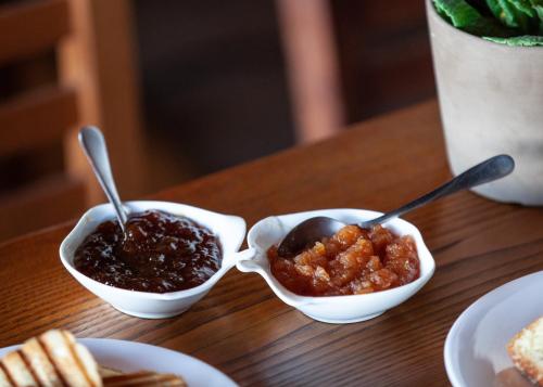 a table with two bowls of food with spoons at Arxontiko Agonari in Metamorfosi