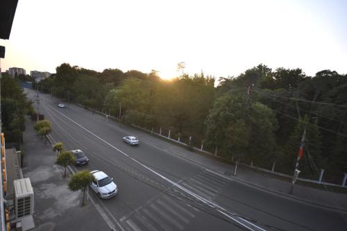 a highway with cars driving down a street with the sun setting at Hotel & Restaurant Sokhumi in Zugdidi