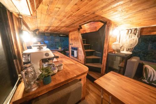 a kitchen in a tiny house with a mixer on a counter at Delightful 2 Bed Double Decker Bus with Hot Tub in Uckfield