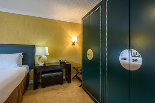 a hotel room with a bed and a desk and a bedroom at The Portland Hotel in Lybster