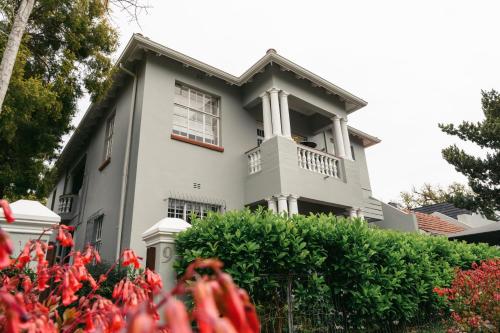 a house with red flowers in front of it at Minserie Collection in Stellenbosch