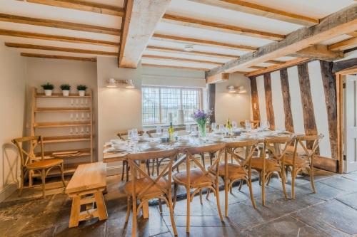 a large dining room with a long table and chairs at The Hunting Lodge at Ragley Estate in Alcester