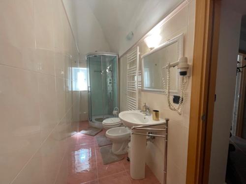 a bathroom with a toilet and a sink and a shower at B&B Le Volte 27 in Gravina in Puglia
