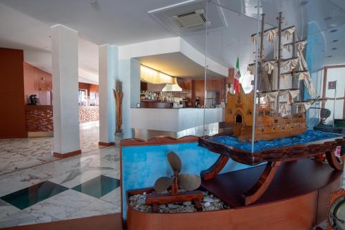 a room with a model of a ship on a table at Best Western Hotel Nettuno in Brindisi