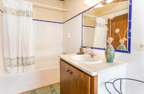 a bathroom with a sink and a mirror and a tub at Turismo Rural Can Massot in Darnius