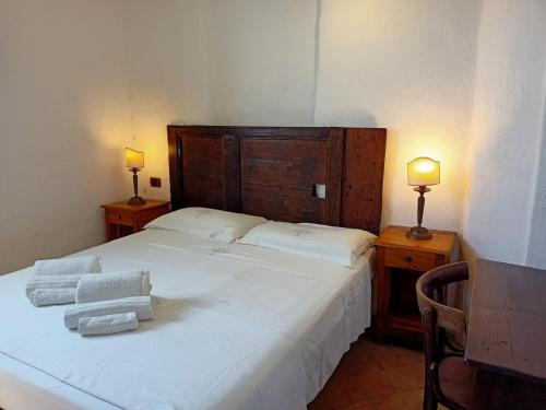 una camera da letto con un grande letto bianco con due lampade di Sardegna Antico casale Cod. IUN Q4789 a Orosei