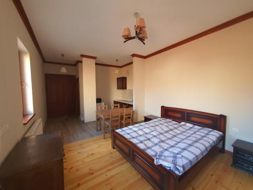 a bedroom with a bed and a dining room at Bereg-Travel in Berehove