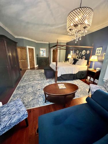 a large bedroom with a bed and a chandelier at Barksdale House Inn in Charleston