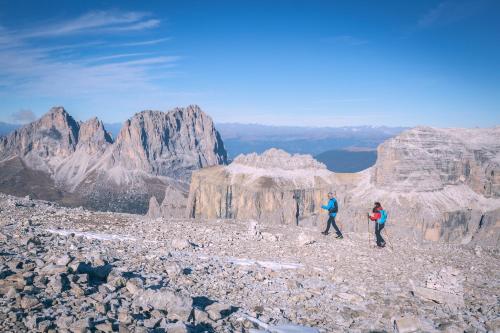 two people walking on the top of a mountain at Fedaia Joy B&B in Canazei