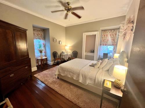 a bedroom with a bed and a ceiling fan at Barksdale House Inn in Charleston