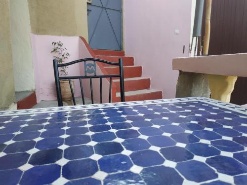 a room with a blue and white tiled floor at Dar Lala Zhour in Aïn Bouchrik