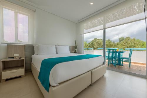 a bedroom with a bed and a view of the ocean at Santo Manglar Cartagena Life Wellness Spa Hotel in Cartagena de Indias