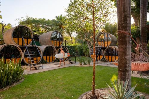 a woman standing in front of a pod house at Pipe House Playa Grande in Playa Grande