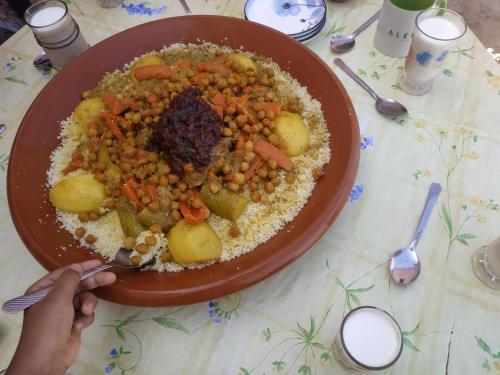 a plate of food with chickpeas and rice on a table at Dar Lala Zhour in Aïn Bouchrik