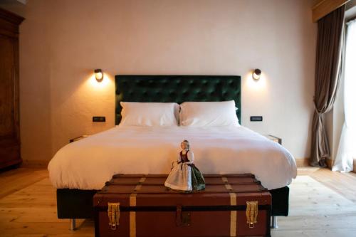 a doll is sitting on top of a bed at Al Capriolo in Vodo Cadore