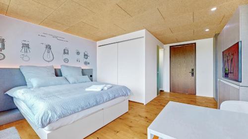 a bedroom with a large bed and a table at Evi's Home Hotel & Apartments in Bern