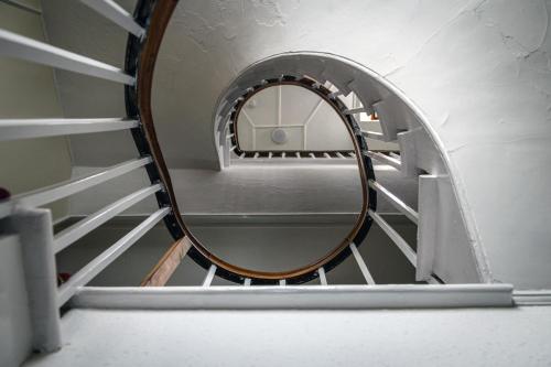 a spiral staircase with a round mirror on it at The Portland Hotel in Lybster