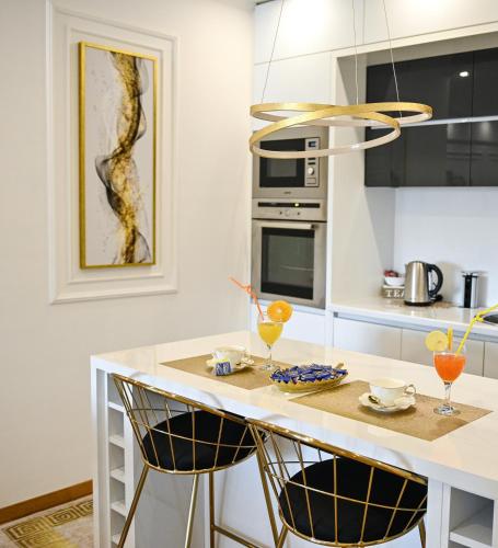 a kitchen with a counter with two glasses on it at Luxury Apartment Karic FREE parking in Tuzla