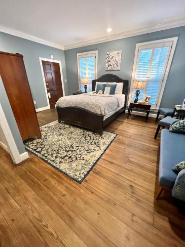 a bedroom with a bed and a wooden floor at Barksdale House Inn in Charleston