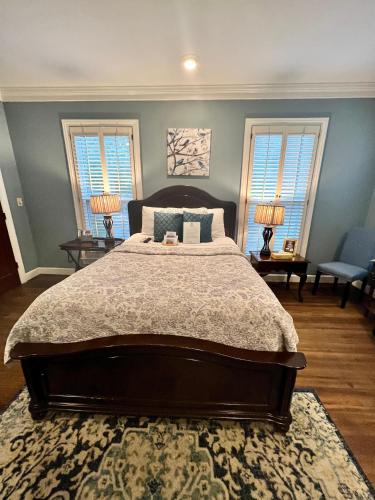 a bedroom with a large bed and two windows at Barksdale House Inn in Charleston
