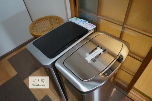 a metal box with a cell phone on top of it at Guest House Atagoya in Kyoto