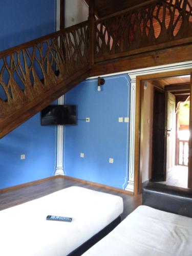 a bunk bed in a room with a blue wall at Недкова къща in Koprivshtitsa