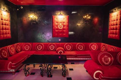 a red couch in a room with a red window at Villa ROYAL CLUB 13 in Jūrmala