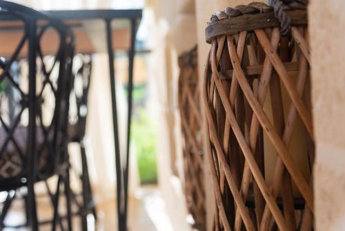 a group of chairs sitting next to a wall at Borgo dei Lecci Puglia in Selva di Fasano
