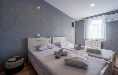 a bedroom with two beds with white sheets and pillows at Art-Gallery Avlabari in Tbilisi City