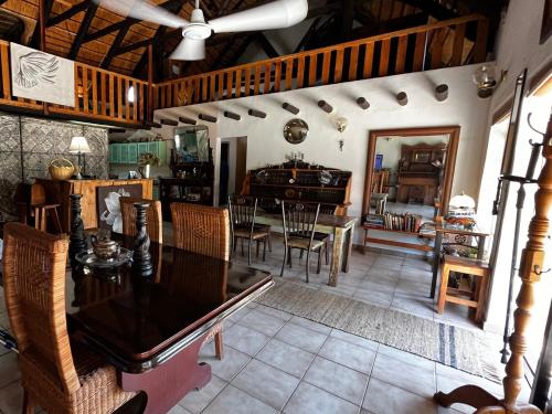 a living room with a table and chairs at OppiPlasie Guest House & SPA in Brits