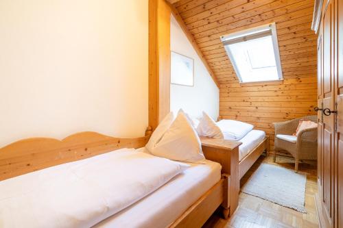 a bedroom with two beds in a wooden cabin at Gasthof-Appartements Sportalm in Bad Kleinkirchheim
