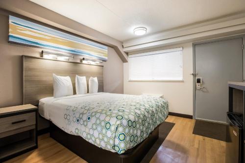 a hotel room with a bed and a window at HomeTowne Studios by Red Roof Princeton - Ewing/ Lawrenceville in Trenton