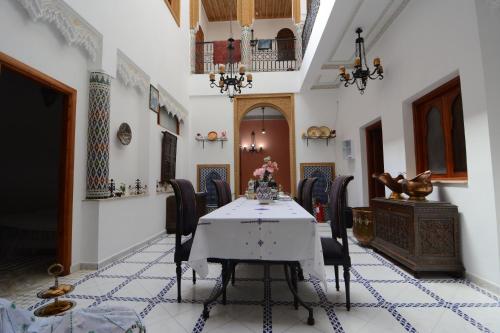 a dining room with a table and chairs at RYAD RDATE LWALIDINE in Marrakesh
