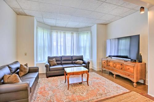 a living room with a couch and a flat screen tv at Walk to Lake Ontario Sodus Point Family Escape in Sodus