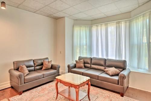 a living room with two leather couches and a table at Walk to Lake Ontario Sodus Point Family Escape in Sodus