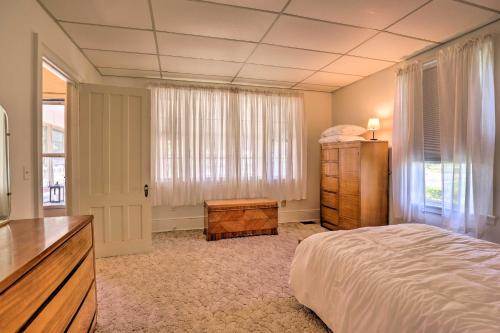 a bedroom with a bed and a dresser and a television at Walk to Lake Ontario Sodus Point Family Escape in Sodus