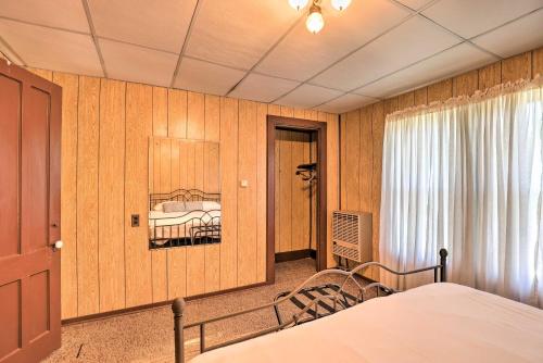 a bedroom with a bed and a painting on the wall at Walk to Lake Ontario Sodus Point Family Escape in Sodus