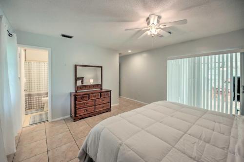 a bedroom with a bed and a mirror and a dresser at Port Charlotte Retreat about 4 Mi to Beach Park! in Port Charlotte