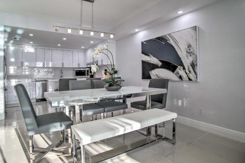 a kitchen and dining room with a table and chairs at Less Than Half-Mi to Beach Sunny Isles Resort Condo in Miami Beach