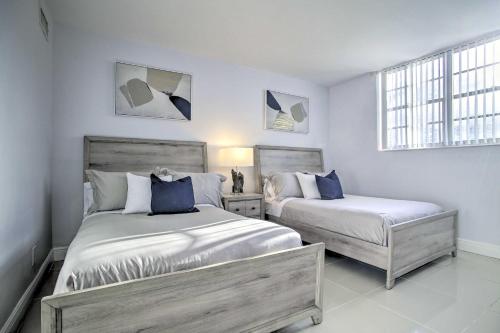 a bedroom with two beds and two windows at Less Than Half-Mi to Beach Sunny Isles Resort Condo in Miami Beach