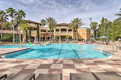a swimming pool at a resort with palm trees at Disney Good Neighbor Resort Condo Less Than 4 Mi to WDW! in Orlando